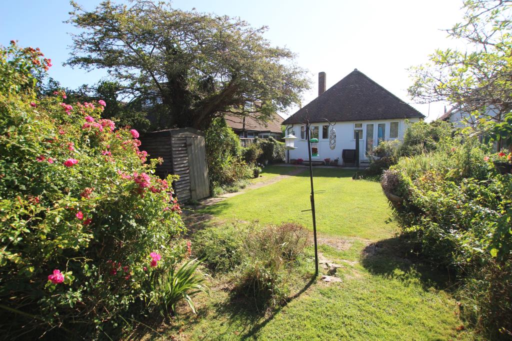 Lot: 129 - DETACHED BUNGALOW LET ON REGULATED TENANCY - rear elevation and garden taken August 2024